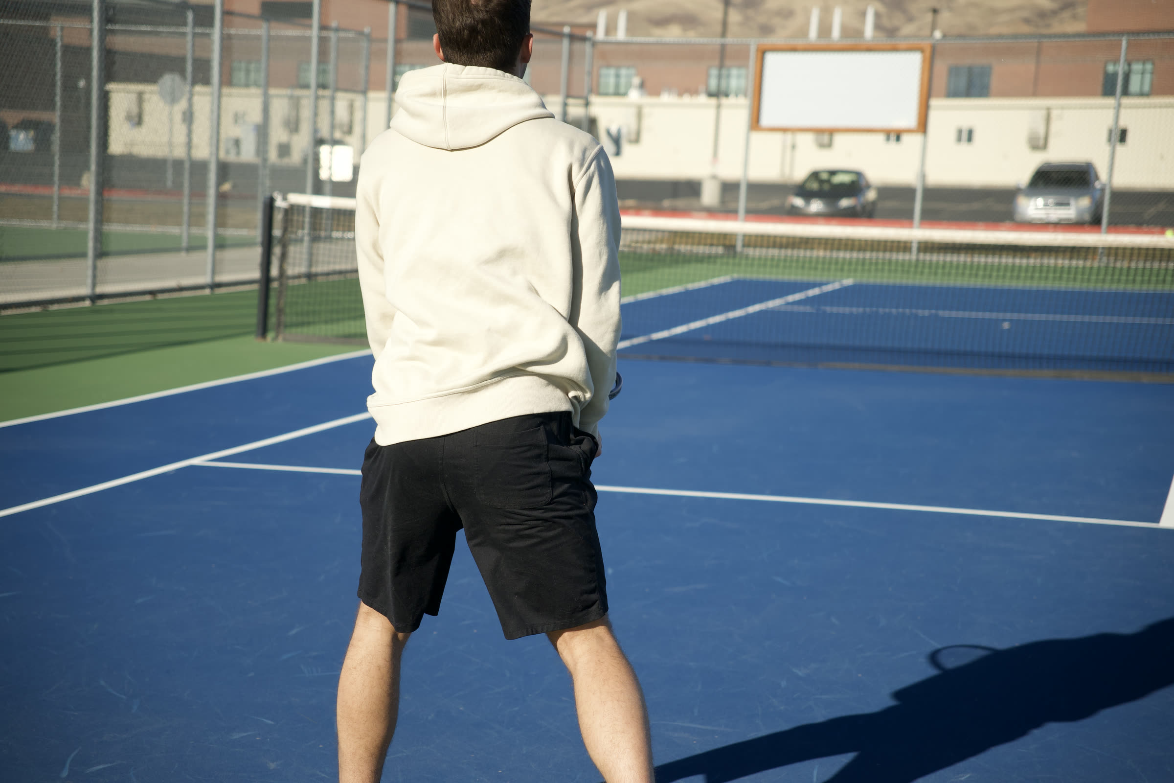 An empty outdoor hard court in low winter sun