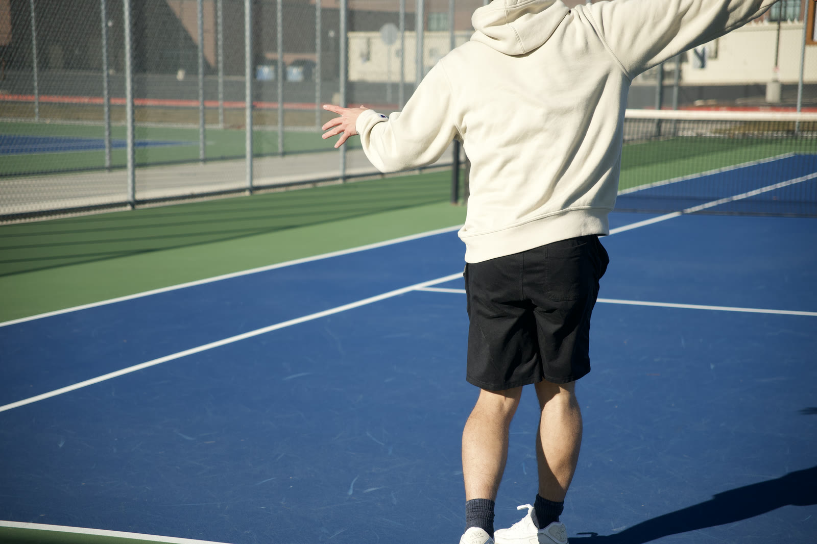 A player at full extension on the serve